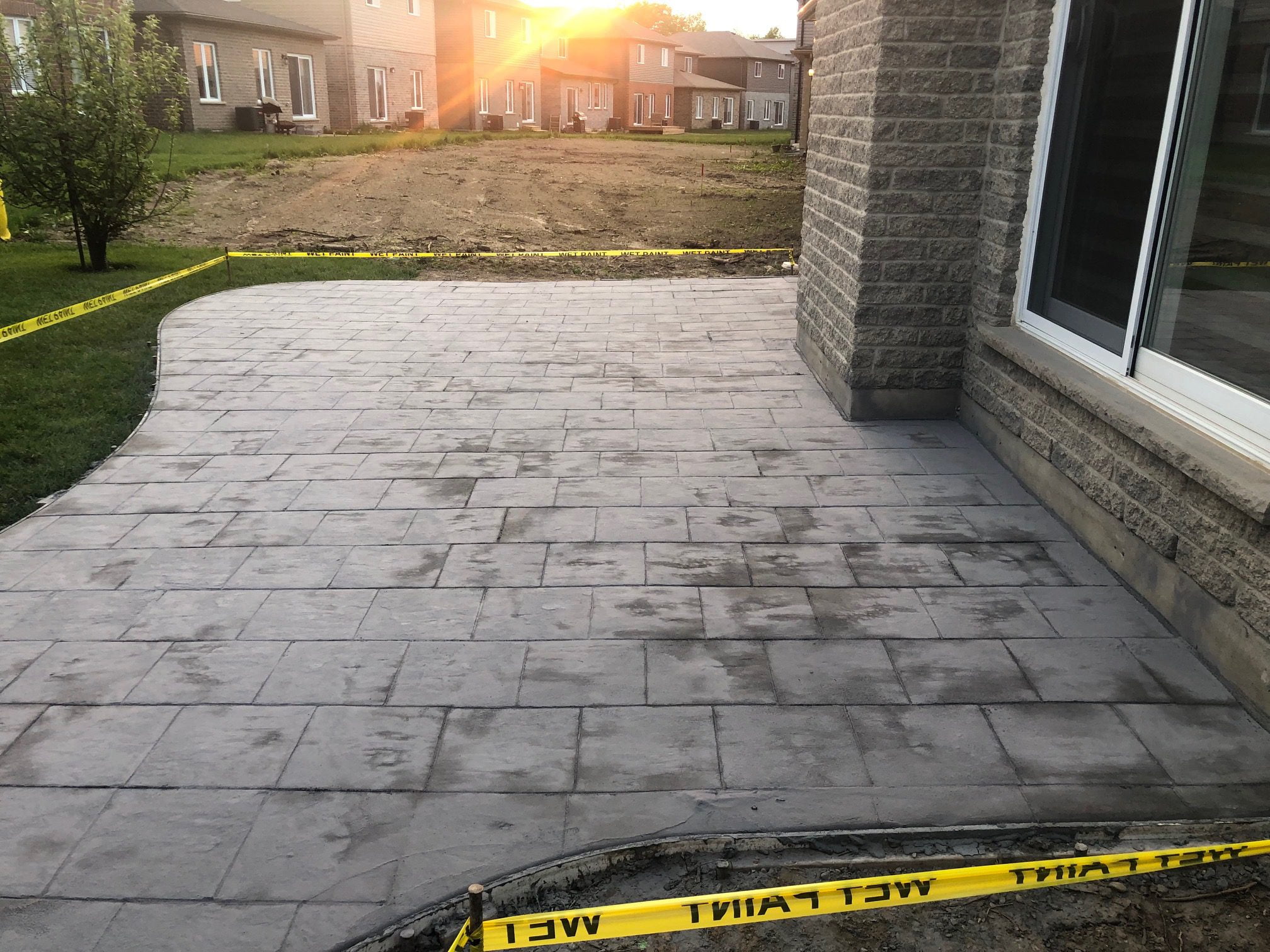 Master Decker Unsealed Stamped Concrete In Backyard